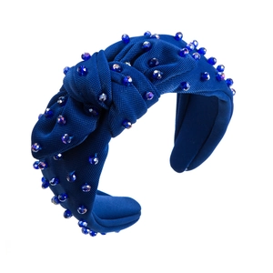 Detail of dark blue fabric headband with crystal beads and knotted center design