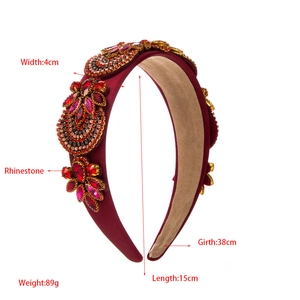 Close-up of burgundy velvet headband with rhinestone flowers and size measurements