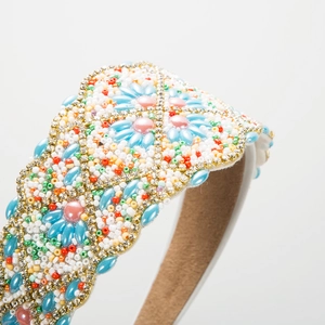 Macro detail of Baroque style wide headband with colorful rhinestone and bead embroidery