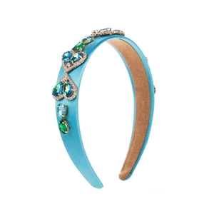 Detail of blue satin headband showing colorful crystal heart stones and anti-slip lining
