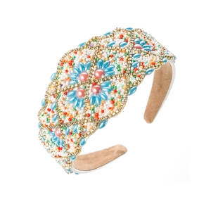 Detailed macro view of hand-beaded baroque headband featuring floral motifs and velvet lining