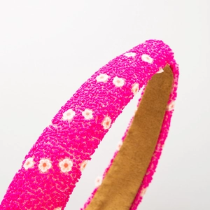 Bright pink padded headband with floral beaded texture and non-slip inner lining