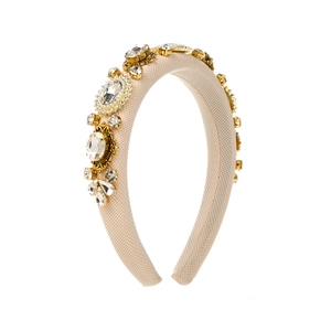 Detailed view of Baroque headband with clear rhinestones on beige knit sponge base
