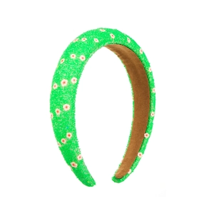 Close-up of green sponge headband featuring textured floral pattern and brown non-slip lining