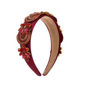 Detail of luxury baroque velvet headband with sparkling burgundy rhinestone flowers