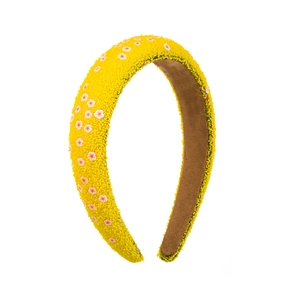 Detail of yellow beaded padded headband with pink and white flower embroidery texture