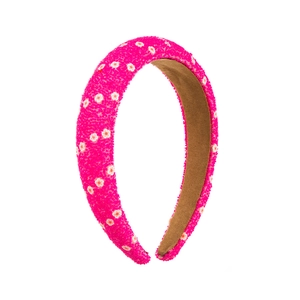 Close-up of rose pink floral headband with textured fabric and anti-slip lining