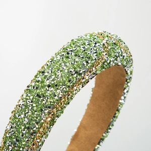 Green rhinestone padded headband with gold chain details and luxury velvet lining