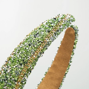 Baroque green and white rhinestone headband with a woven gold metal chain accent