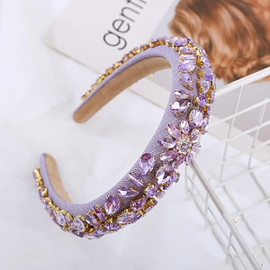 Macro detail of purple rhinestone flower clusters on baroque padded headband