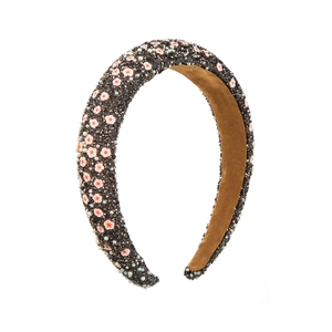 Close-up of padded sponge headband with black beads, pink petals and pearls