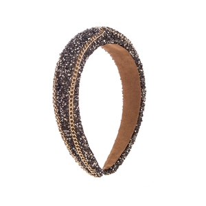 Detail view of heavy-duty headband featuring dark rhinestones and golden metal chains
