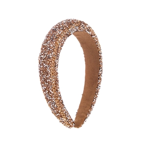 Close-up of champagne rhinestones and gold chain on wide sponge headband with brown lining