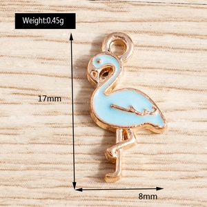 Macro detail of a rose gold flamingo pendant with blue enamel and 17mm height measurement
