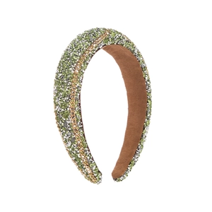 Baroque padded headband with green rhinestones and a gold chain detail on white background