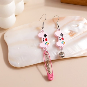 Detail of pink game controller earrings with safety pin tassels and crystal studs
