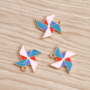 Macro detail of colorful windmill alloy charms with golden metal edges for DIY crafting
