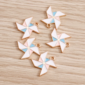 Detail of colorful enamel windmill charms with gold metal frames for DIY jewelry