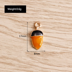 DIY acorn charms in black and orange enamel finish with gold base for jewelry making