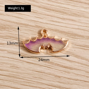 Detail view of purple gradient bat wing charm with size and weight measurements
