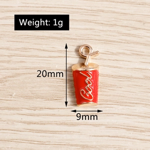 Macro detail of red enamel cola cup charm with gold trim and size 20mm by 9mm