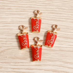 Detailed view of red enamel beverage cup charms with gold Cool lettering for DIY jewelry
