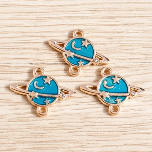 Detail of blue enamel planet charms with gold plating and dual hanging loops for DIY jewelry