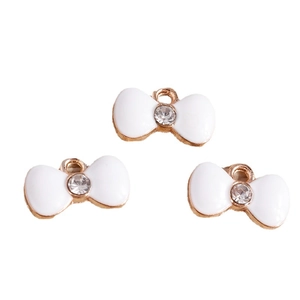 Three white enamel bow pendants with rose gold edges and crystal center for DIY jewelry