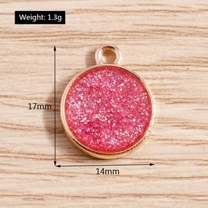 Detailed view of pink glitter round alloy pendant with dimensions 17x14mm for DIY jewelry