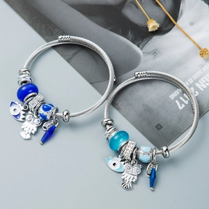 Adjustable wire bangles with blue owl charms and evil eye beads in bohemian style
