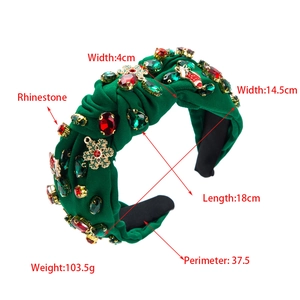 Détail du bandeau noué vert foncé avec strass rouges et breloques de Noël