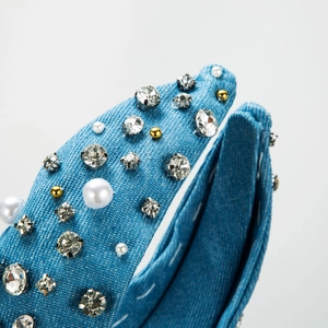 Blue denim headband featuring pearl and rhinestone embellishments in a knotted wide design