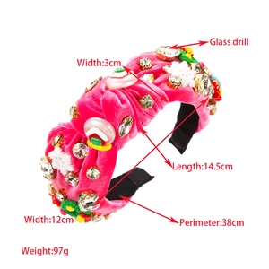 Detail view of pink velvet Christmas headband with rhinestones and gingerbread house decor