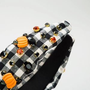 Cerchietto per Halloween in tessuto a scacchi bianco e nero con decoro a zucca
