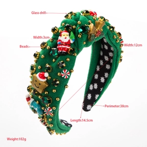 Detail view of green velvet Christmas headband with Santa, bells and glass crystals