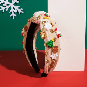 Close-up of velvet Christmas headband with decorative Santa, tree and gemstone details