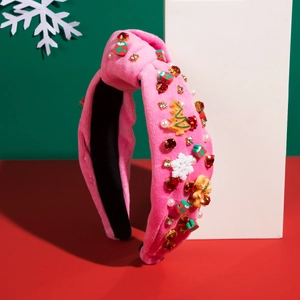 Close-up of pink velvet Christmas headband with rhinestones, trees and gingerbread man
