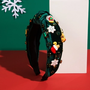 Close-up of green velvet Christmas headband with snowflake and gingerbread resin charms