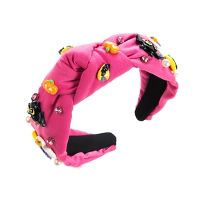 Pink knotted Halloween headband with glitter pumpkins, bats, rhinestones and pearls