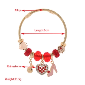 Adjustable gold beaded bangle with red rhinestones and high heel heart charms