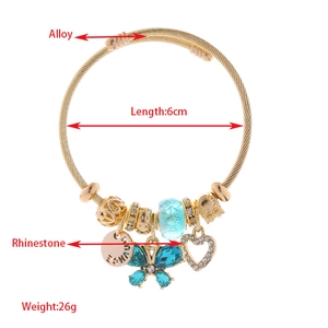 Bracciale rigido dorato regolabile con farfalla blu e ciondolo a cuore con strass