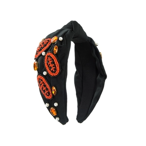 Détails de broderie de rugby à la main avec perles et strass orange sur serre-tête large noir