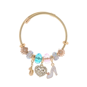 Detail of adjustable gold charm bracelet with high heel and crystal heart pendants