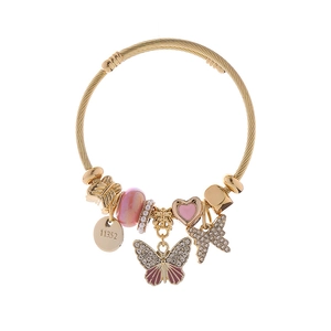 Detail of DIY bead bracelet with butterfly pendant, pink enamel heart, and sparkling crystals