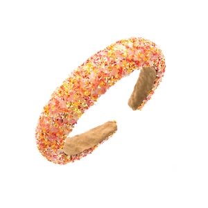 Macro detail of high-volume sponge headband with sparkling orange and yellow resin sequins