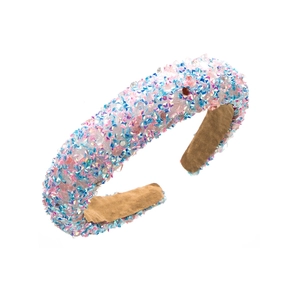 Detail of sequin padded headband featuring sparkly glitter finish and soft suede lining