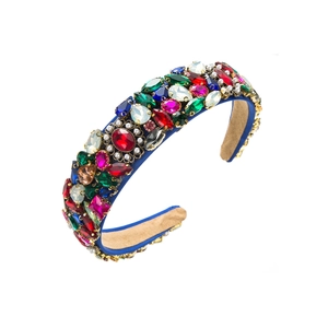 Detailed close-up of Baroque velvet headband with multi-color crystals and pearls