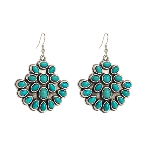 Detailed close-up of fan-shaped boho earrings with white turquoise and oxidized silver finish