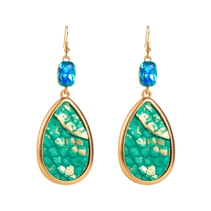 Detail view of water drop earrings with green snakeskin texture and blue crystal