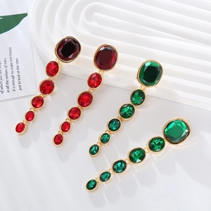 Exaggerated long fringe earrings with red and green oval glass stones in gold setting